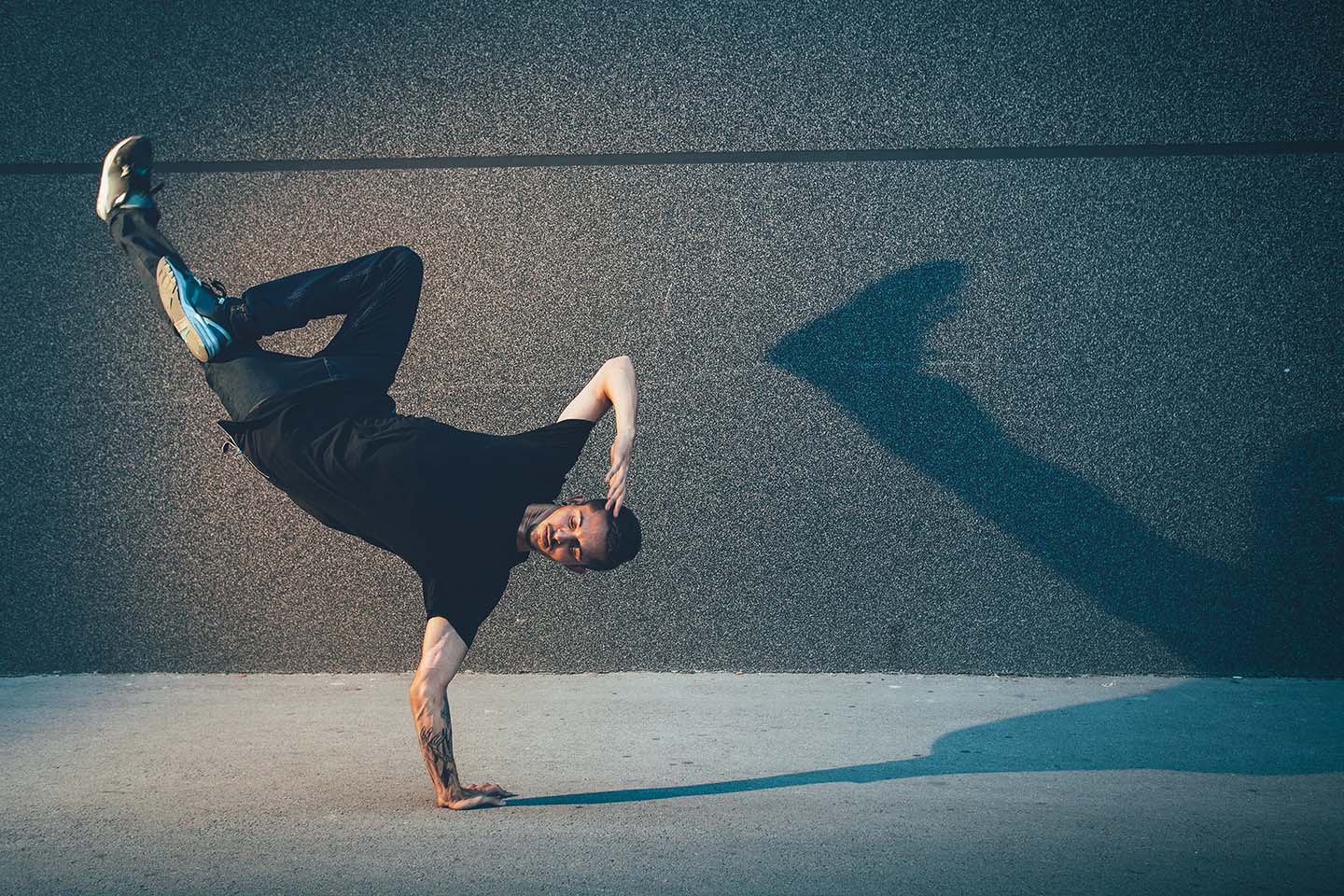 BBoy dancing and doing handstand on street